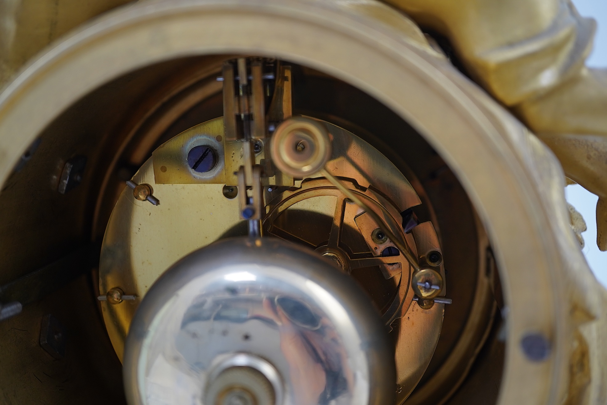 An early 19th century French figural ormolu and white marble mantel clock